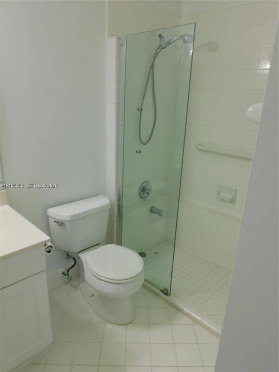 16729 Amber Lake, Weston, FL 33331 Downstairs Bathroom with Glass-enclosed shower with a handheld showerhead and wall-mounted grab bar