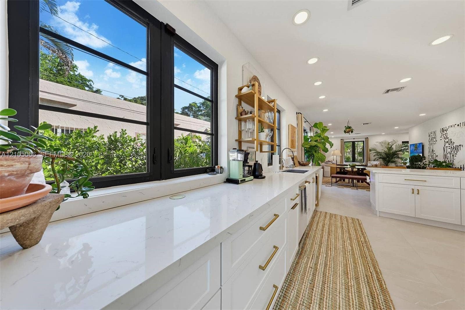 1230 Genoa Street, Coral Gables, Coral Gables, FL 33134 Kitchen featuring white cabinetry with gold-toned hardware, solid-surface countertops, recessed lighting, and black-framed windows