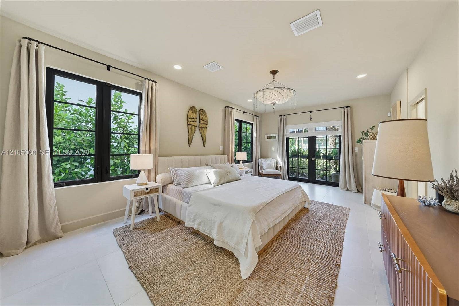 1230 Genoa Street, Coral Gables, Coral Gables, FL 33134 Neutral interior featuring large-format tile flooring, recessed lighting, a modern multi-tiered chandelier, black-framed windows, and a set of glass-paned double doors