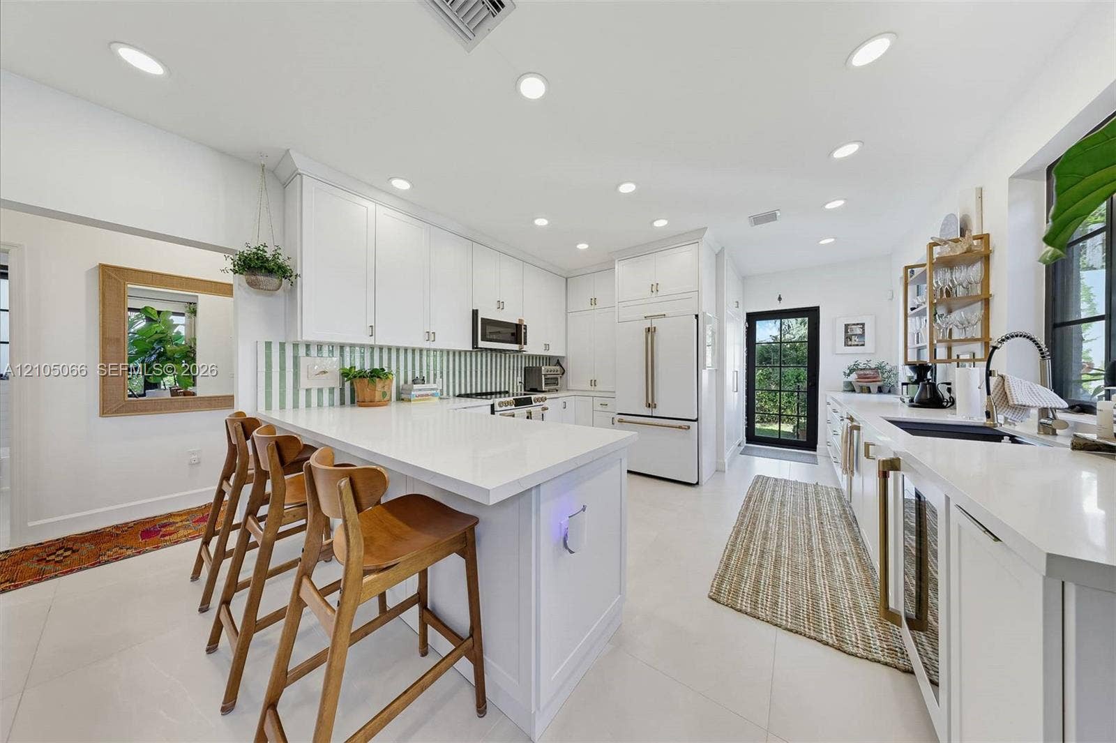 1230 Genoa Street, Coral Gables, Coral Gables, FL 33134 Kitchen featuring white cabinetry, quartz countertops, a striped backsplash, recessed lighting, and a built-in wine refrigerator