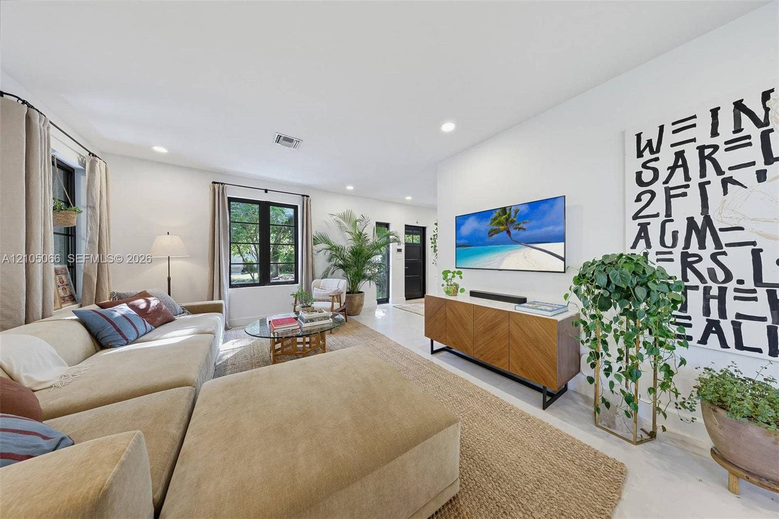 1230 Genoa Street, Coral Gables, Coral Gables, FL 33134 Neutral interior space featuring high ceilings, black-framed multi-pane windows, and light-toned flooring