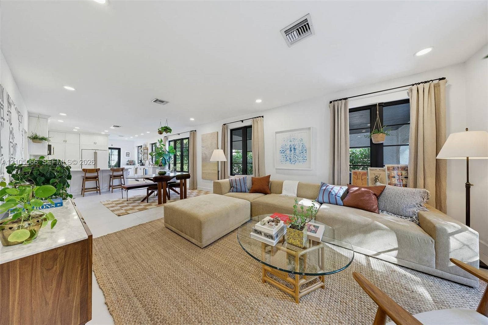 1230 Genoa Street, Coral Gables, Coral Gables, FL 33134 Open-concept interior featuring light-toned flooring, recessed lighting, and expansive windows with black frames