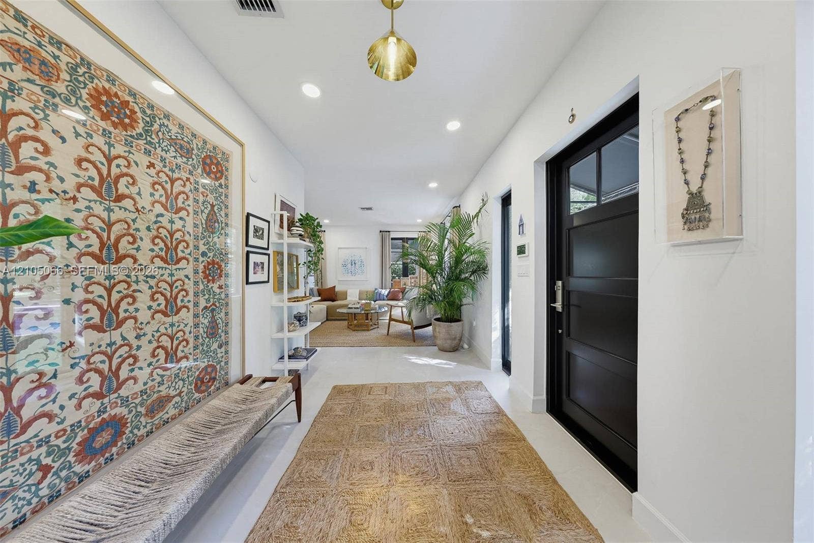 1230 Genoa Street, Coral Gables, Coral Gables, FL 33134 Entryway featuring a black multi-panel door with glass inserts, recessed lighting, and a pendant fixture with a metallic finish