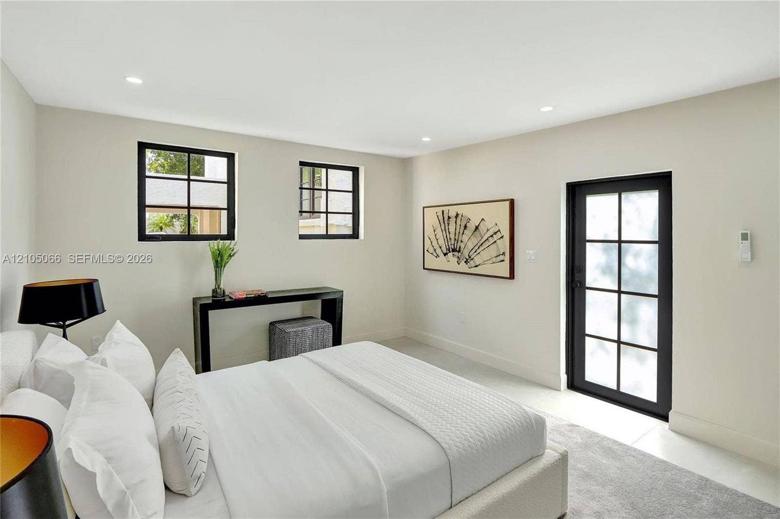 1230 Genoa Street, Coral Gables, Coral Gables, FL 33134 Neutral-toned interior featuring recessed lighting, two multi-pane windows with black frames, and a glass-paneled exterior door with a black frame