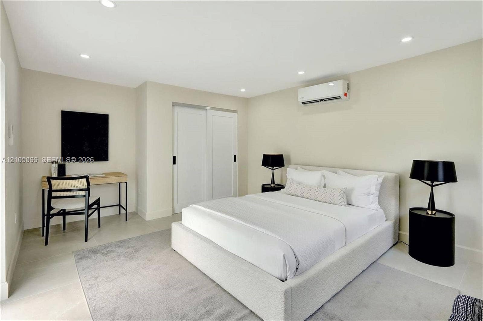 1230 Genoa Street, Coral Gables, Coral Gables, FL 33134 Neutral-toned interior featuring recessed lighting, a wall-mounted climate control unit, and double sliding closet doors