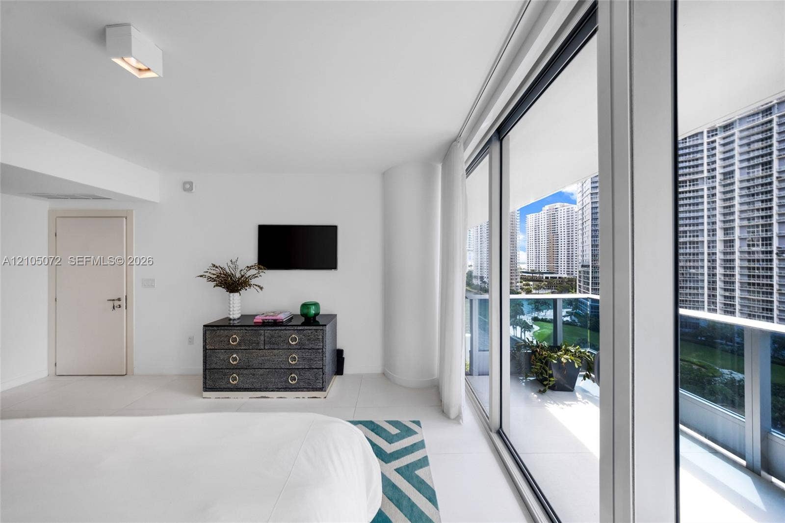 Primary bedroom with large sliding glass doors and direct access to its upper terrace.