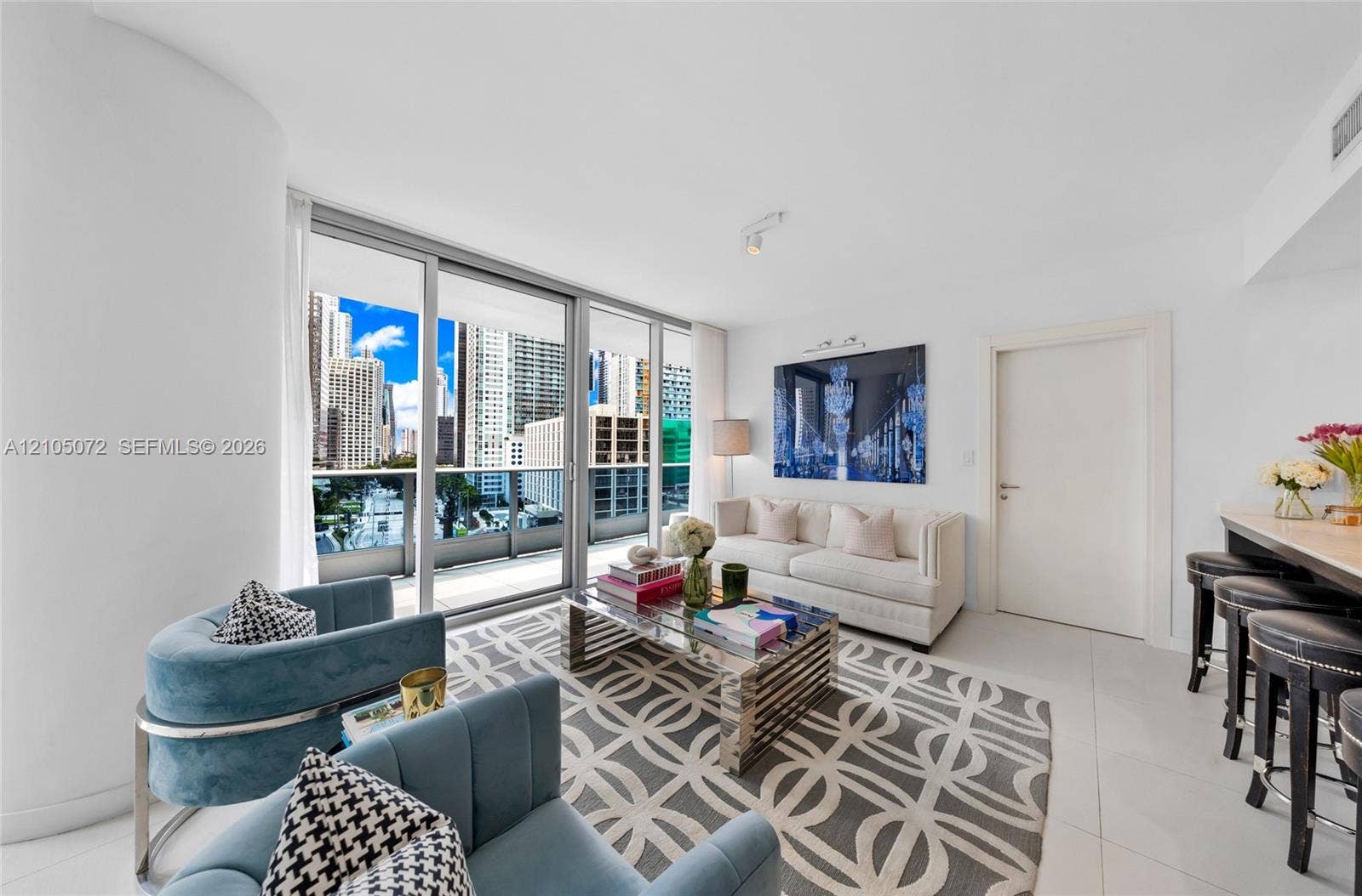 Living room seating adjacent to sliding doors opening onto the lower terrace.