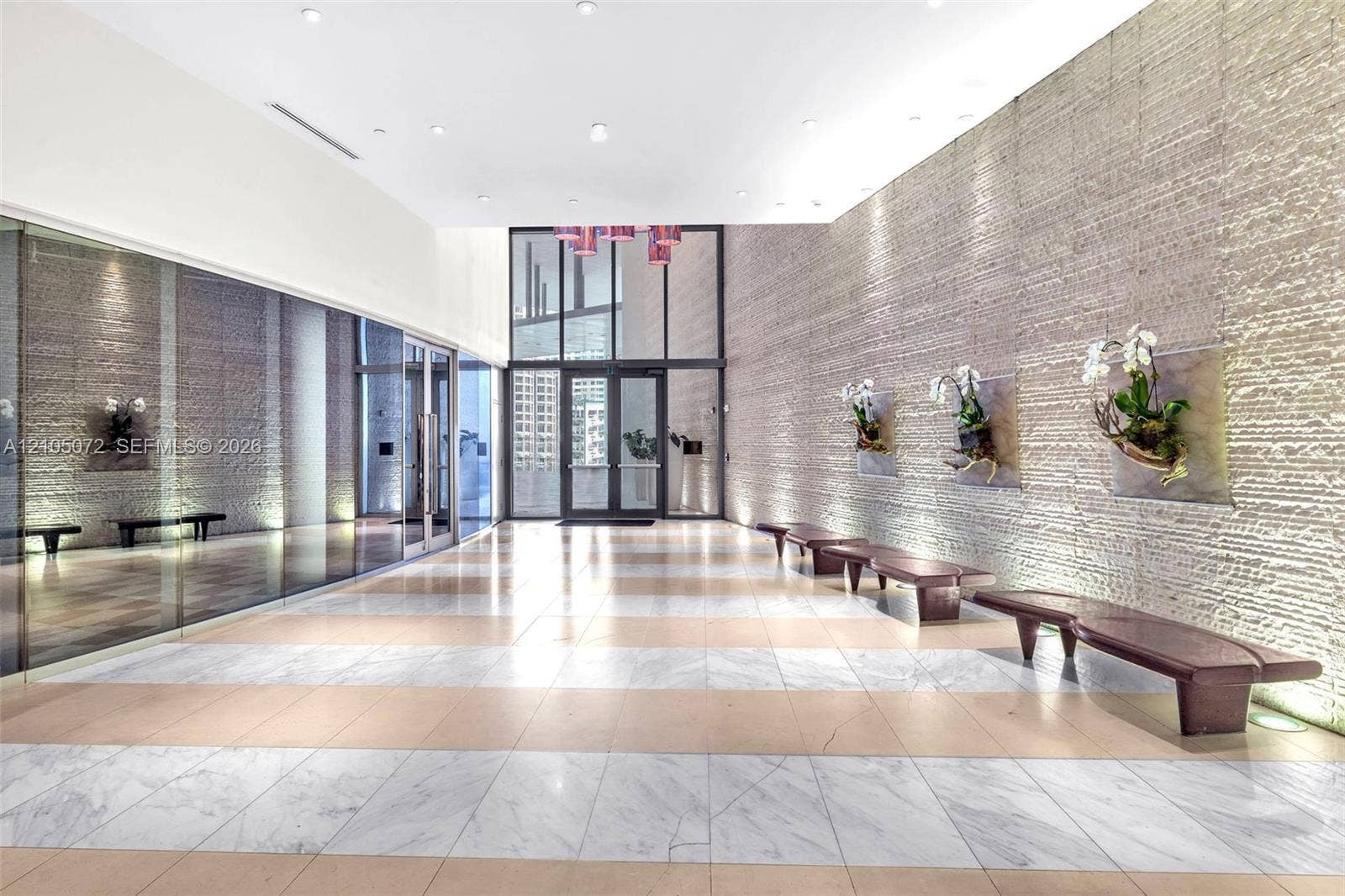 Epic Residences lobby with stone-clad walls and bench seating.