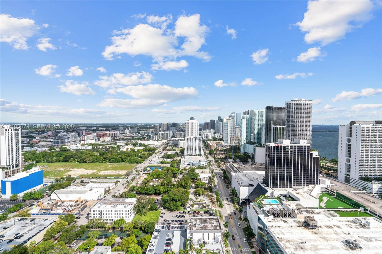 Elevated urban panorama featuring expansive skyline reaches, waterfront proximity, and metropolitan streetscapes