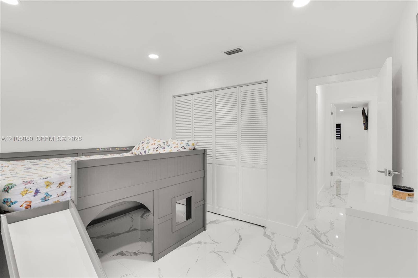 9755 SW 148th Court, Miami, FL 33196 Large-format tile flooring with veined detailing, recessed ceiling lighting, and floor-to-ceiling louvered closet doors