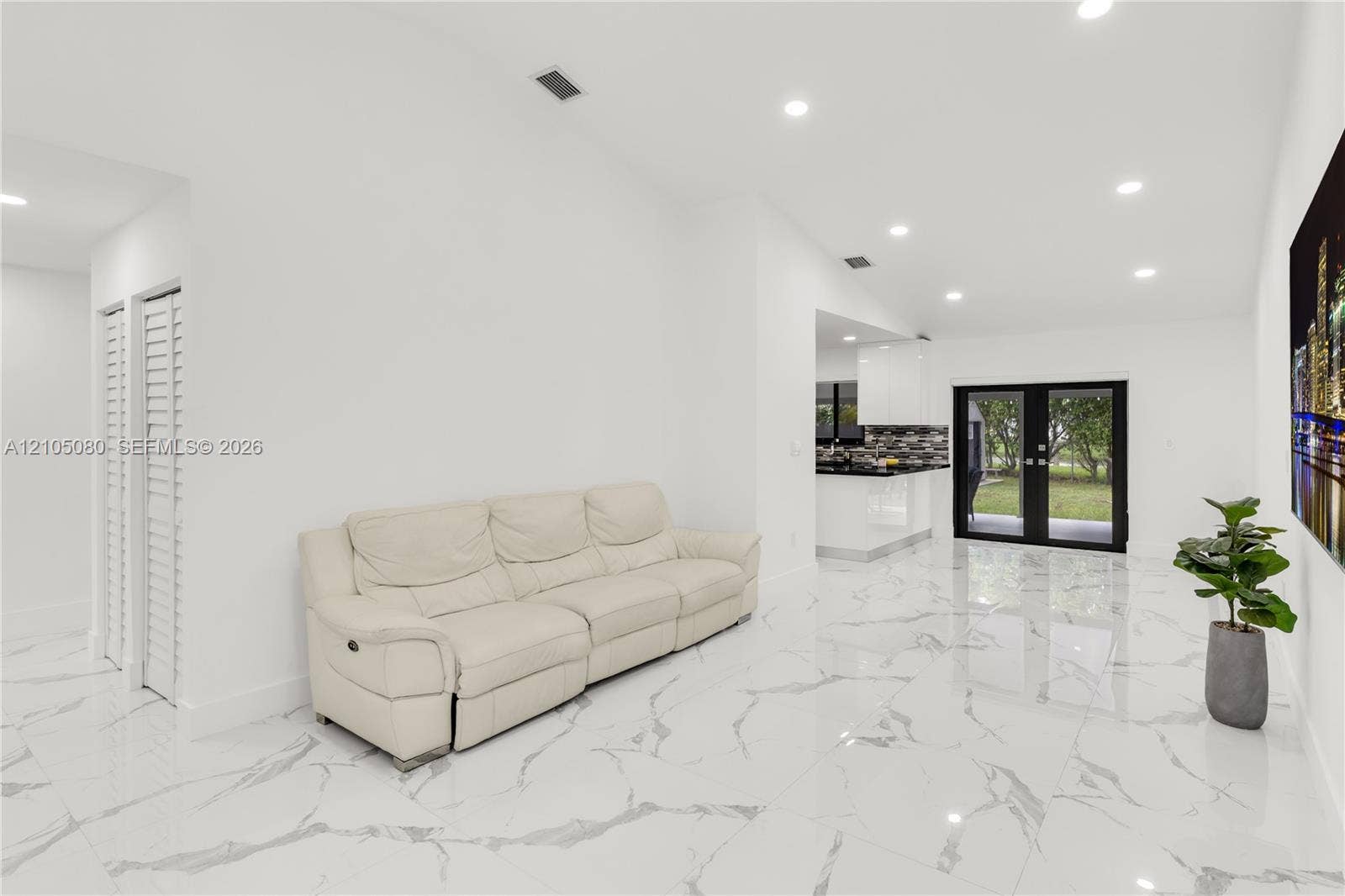 9755 SW 148th Court, Miami, FL 33196 Large-format polished tile flooring, recessed ceiling lighting, and black-framed double glass doors