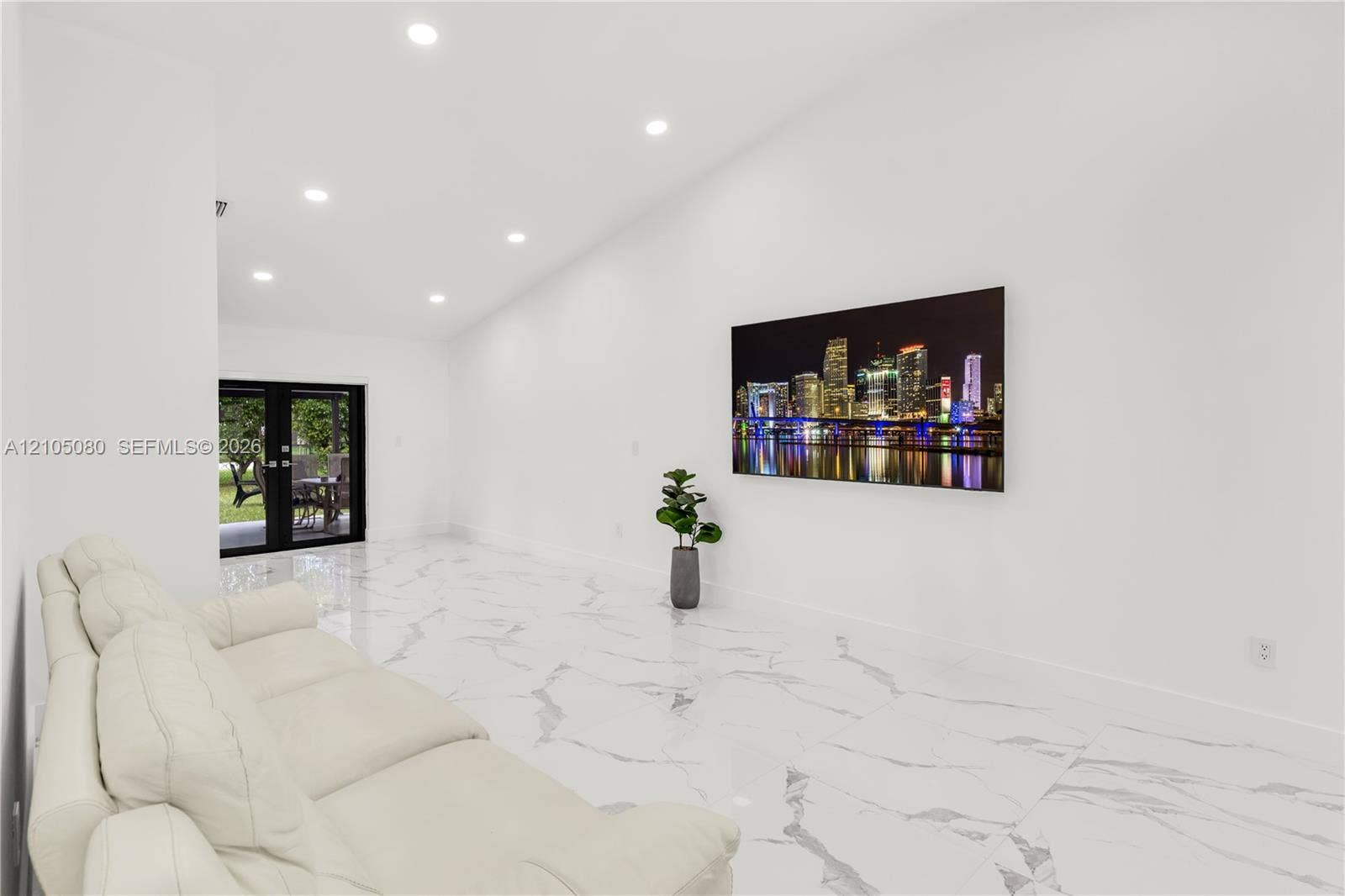 9755 SW 148th Court, Miami, FL 33196 Vaulted ceiling featuring recessed lighting, large-format polished tile flooring, and black-framed French doors