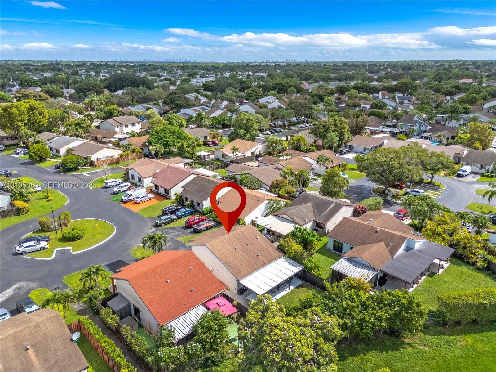 9755 SW 148th Court, Miami, FL 33196 Aerial perspective of property featuring a neutral-toned exterior, concrete roof tiles, and an expansive covered rear patio