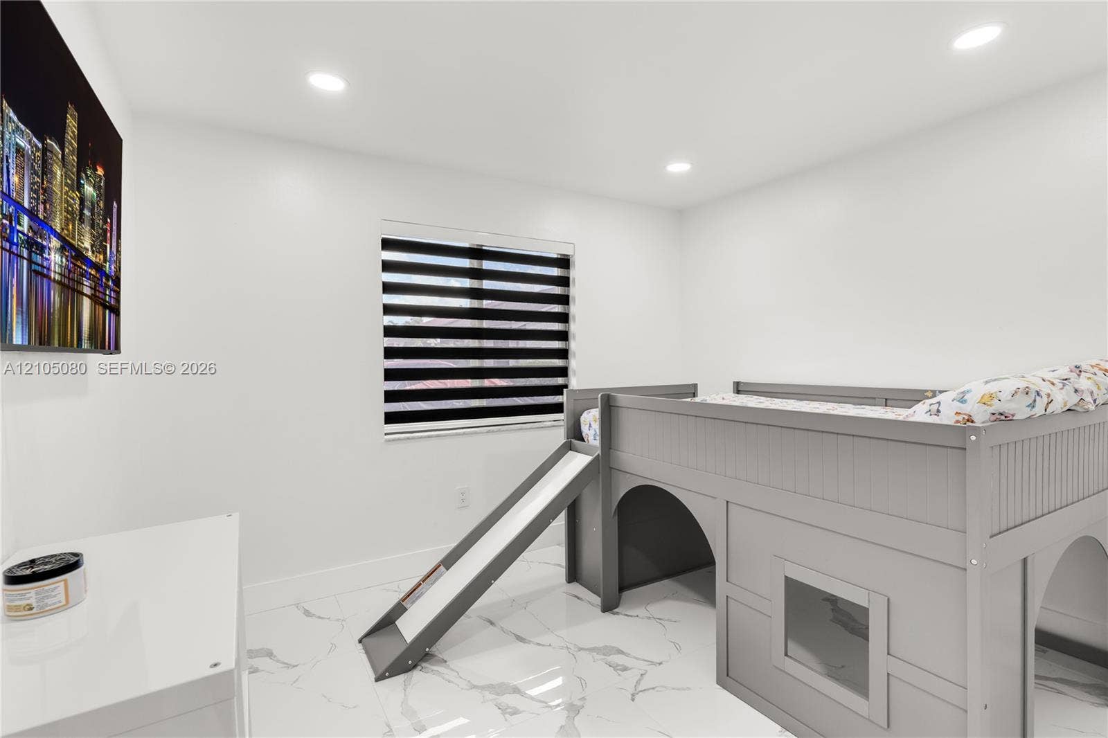 9755 SW 148th Court, Miami, FL 33196 Interior space featuring white tile flooring with grey veining, recessed lighting, and a window with dual-layer zebra roller blinds