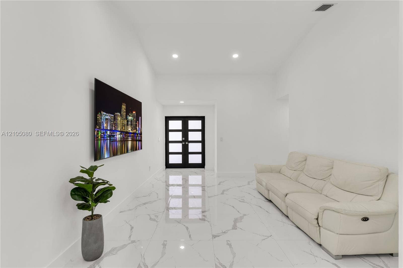 9755 SW 148th Court, Miami, FL 33196 High-ceilinged entry featuring stone-finish flooring with veining, recessed lighting, and black-framed double doors with inset glass panels