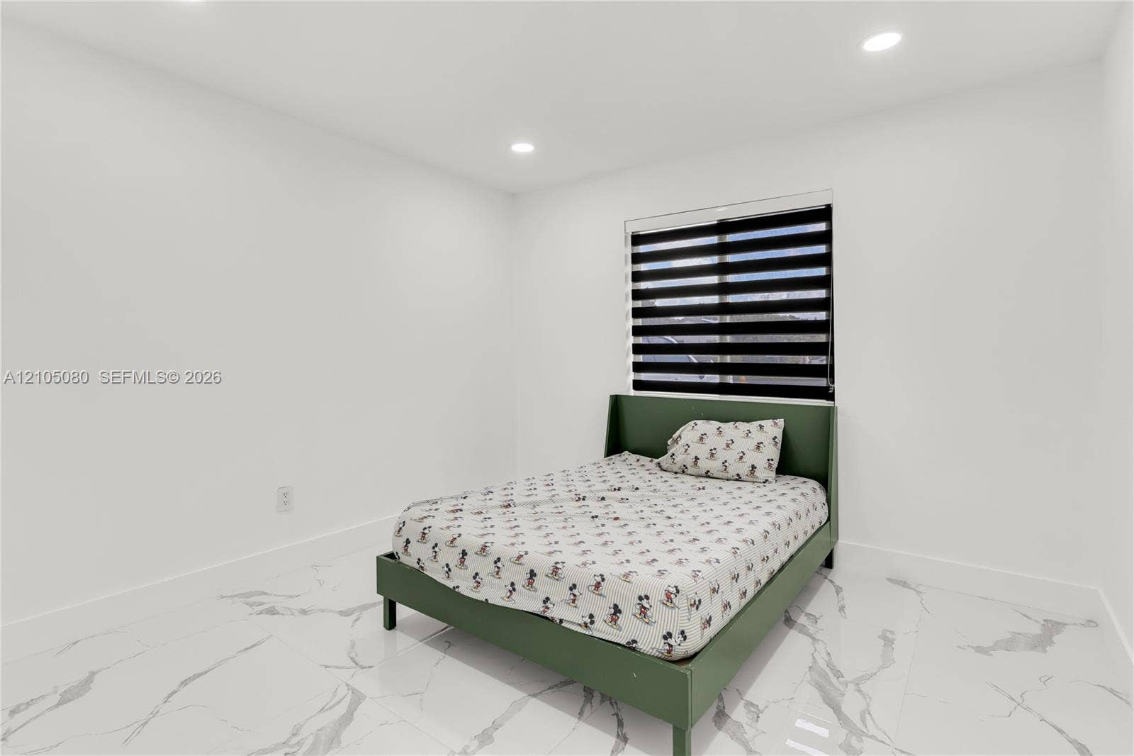 9755 SW 148th Court, Miami, FL 33196 Bright room featuring white walls, white stone-finish tile flooring, recessed ceiling lighting, and a dual-shade roller window blind
