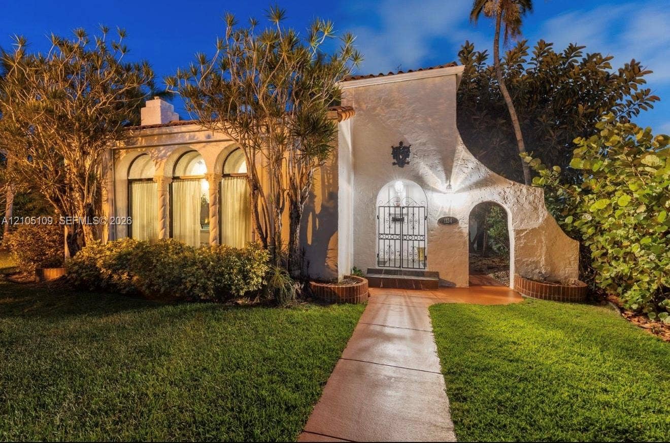 1134 Harrison Street, Hollywood, Hollywood, FL 33019 Stucco exterior with an arched entry, prominent arched windows, and an ornamental gate