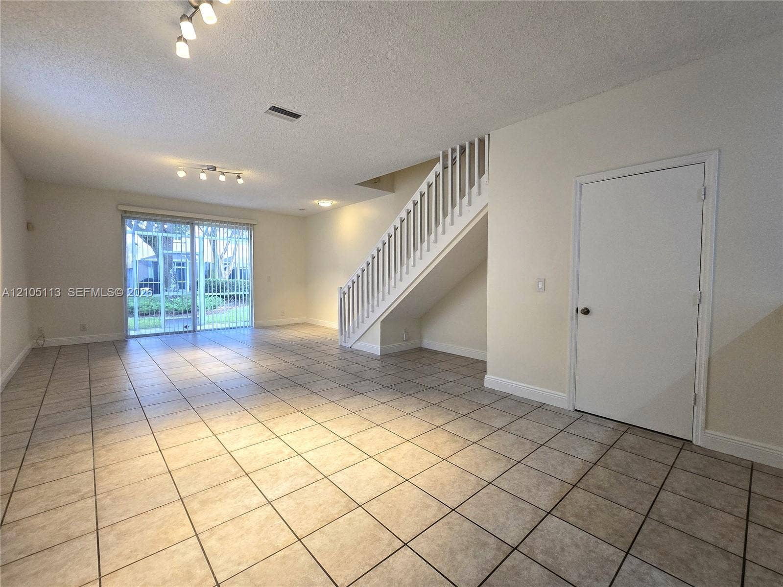2020 Pompeii Court, Weston, Weston, FL 33327 Expansive tile flooring, sliding glass doors to exterior, white painted staircase, and recessed lighting