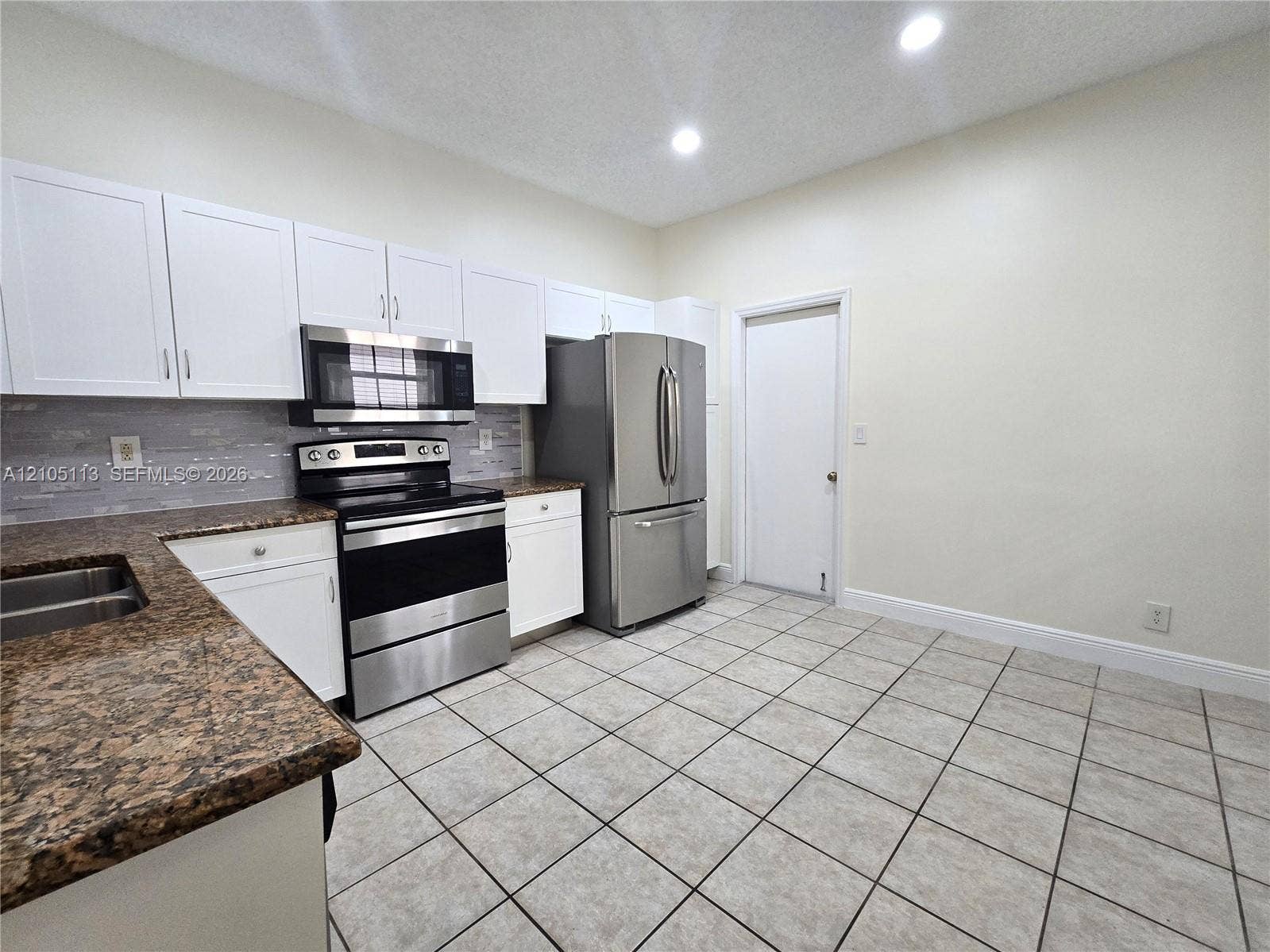 2020 Pompeii Court, Weston, Weston, FL 33327 Kitchen featuring white cabinetry, stainless steel appliances, speckled countertops, a tile backsplash, and recessed lighting