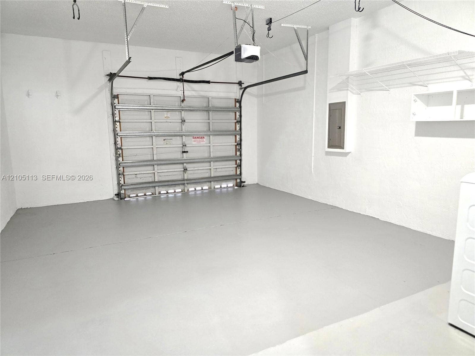 2020 Pompeii Court, Weston, Weston, FL 33327 Garage with a finished floor, automatic garage door, and built-in overhead shelving
