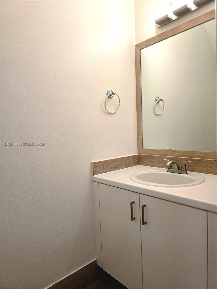 2020 Pompeii Court, Weston, Weston, FL 33327 Vanity with wood-finish countertop, integrated sink, and white cabinetry