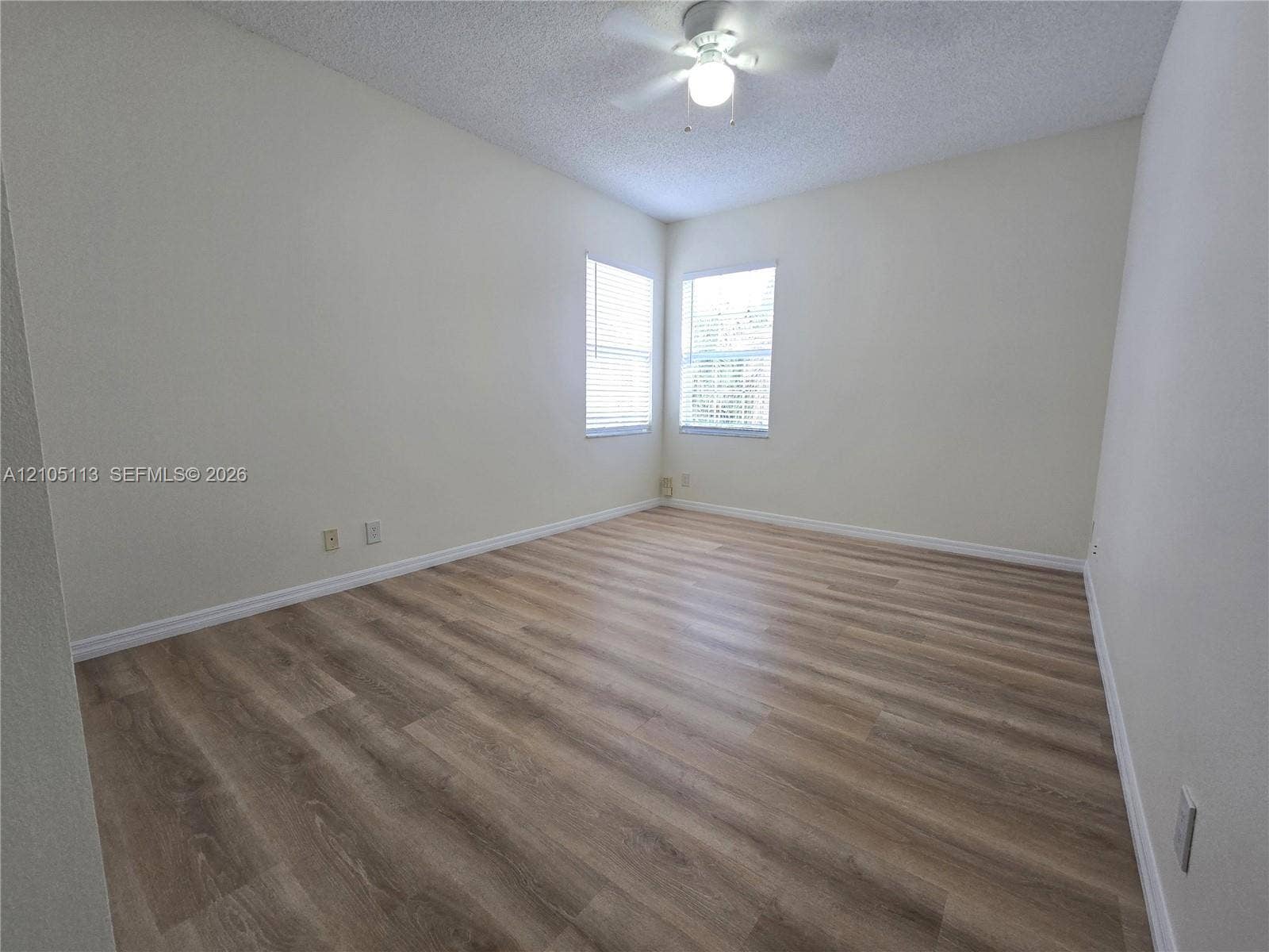2020 Pompeii Court, Weston, Weston, FL 33327 Wood-finish flooring, multiple windows with blinds, ceiling fan, and sloped ceiling