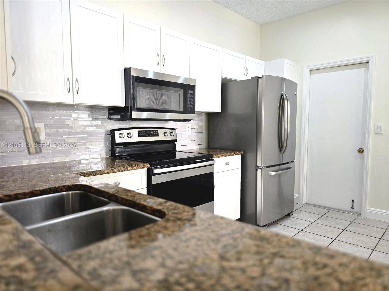 2020 Pompeii Court, Weston, Weston, FL 33327 Kitchen featuring white cabinetry, stone-finish countertops, stainless steel appliances, and a mosaic tile backsplash