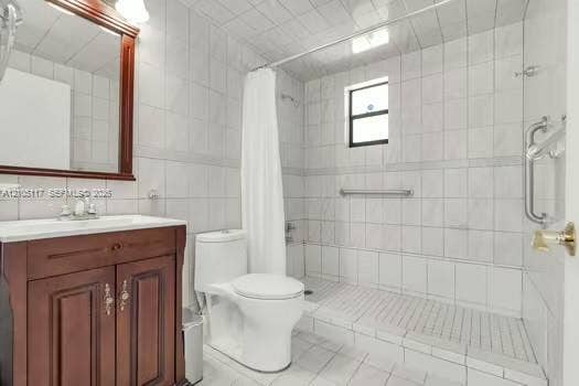 6851 SW 32nd Street, Miami, FL 33155 Full-height tiled bathroom featuring a walk-in shower with grab bars, a cherry-wood finish vanity, and a framed wall mirror