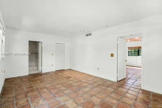 6851 SW 32nd Street, Miami, FL 33155 Interior room featuring terracotta tile flooring, recessed ceiling lighting, and multi-panel solid-core interior doors