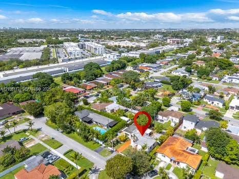 6851 SW 32nd Street, Miami, FL 33155 Aerial perspective of a residential property featuring a multi-pitched roofline, paved driveway, established landscaping, and mature trees