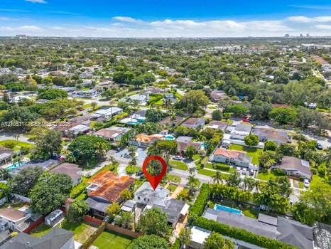 6851 SW 32nd Street, Miami, FL 33155 Aerial view of a residential property featuring a single-story home, a private backyard swimming pool, mature perimeter landscaping, and an asphalt driveway