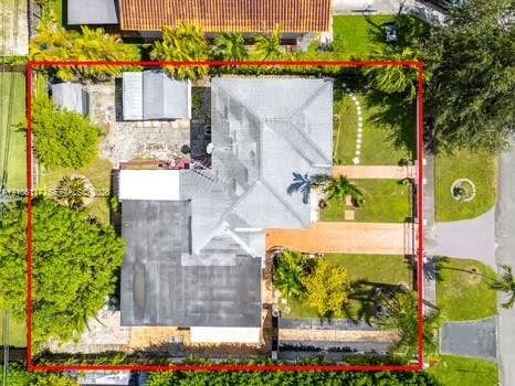 6851 SW 32nd Street, Miami, FL 33155 Aerial view featuring a multi-section roofline, paved driveway, detached storage structure, mature landscaping, and an enclosed backyard