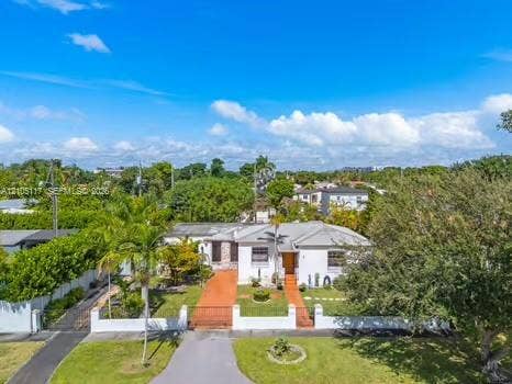 6851 SW 32nd Street, Miami, FL 33155 Single-story residence featuring a light-toned exterior, concrete tile roof, gated masonry wall, and paved driveway