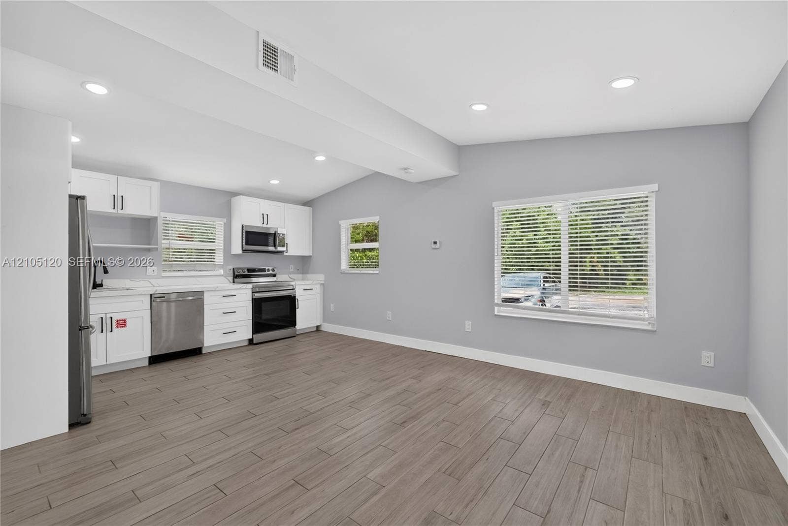 Fort Lauderdale, Fort Lauderdale, FL 33315 Kitchen featuring white cabinetry, stainless steel appliances, wood-finish flooring, and recessed ceiling lighting