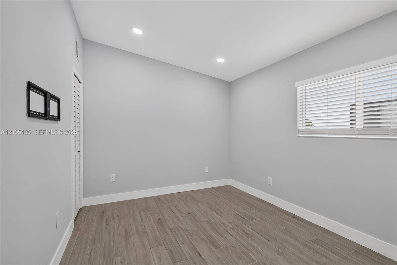 Fort Lauderdale, Fort Lauderdale, FL 33315 Neutral interior featuring wood-finish flooring, recessed lighting, and horizontal window blinds