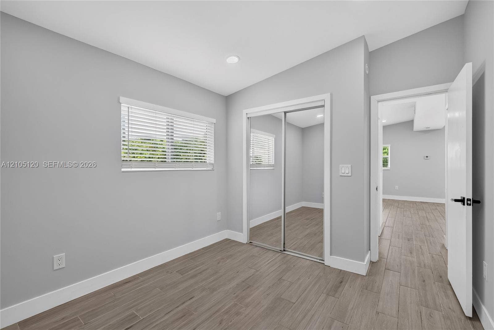 Fort Lauderdale, Fort Lauderdale, FL 33315 Wood-finish plank flooring, neutral wall tones, recessed lighting, and a closet with sliding mirrored doors