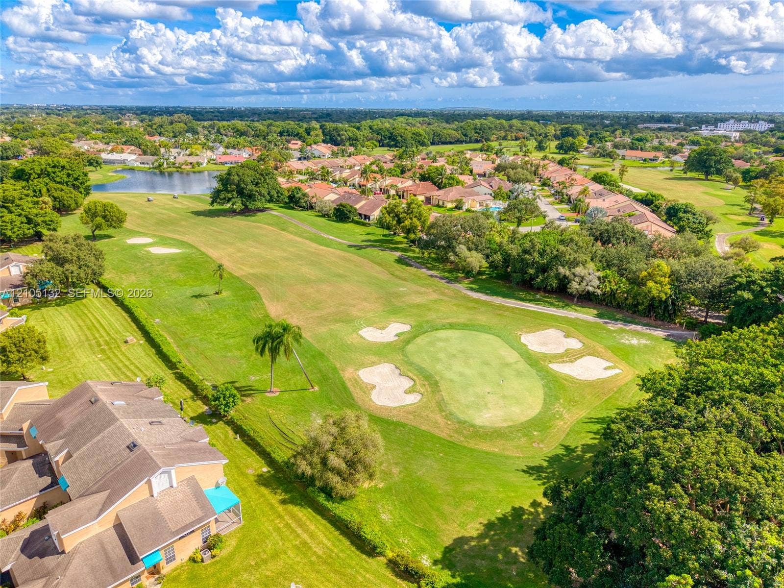 Expansive golf course property featuring manicured greens and sand traps