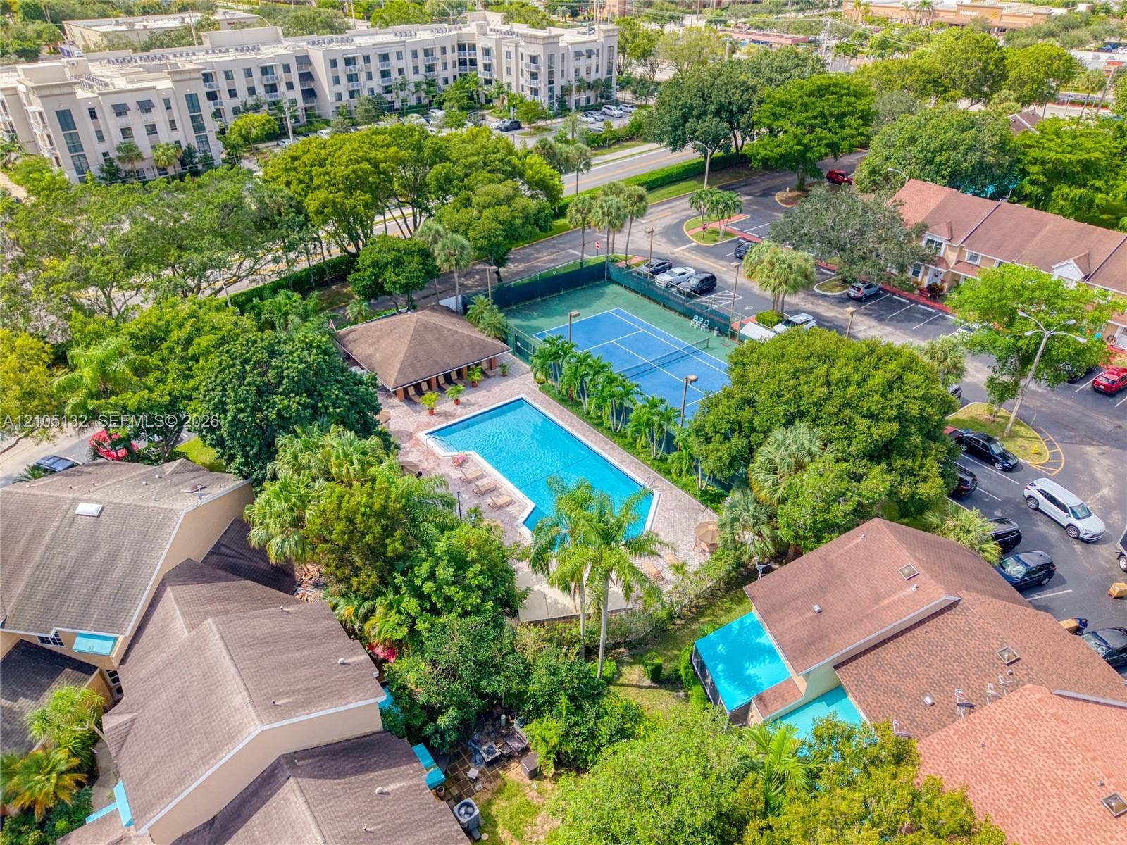 Community amenities featuring a swimming pool, tennis court, pool deck, and shaded cabana