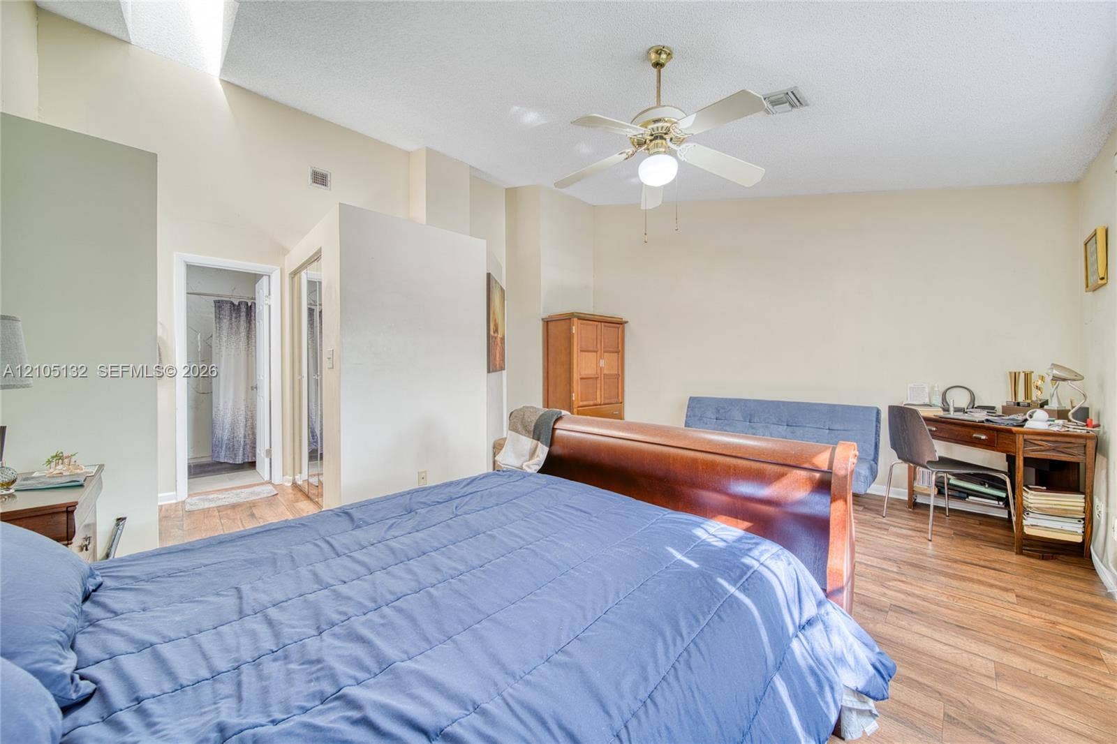 Vaulted ceiling, wood-finish flooring, ceiling fan, and recessed lighting