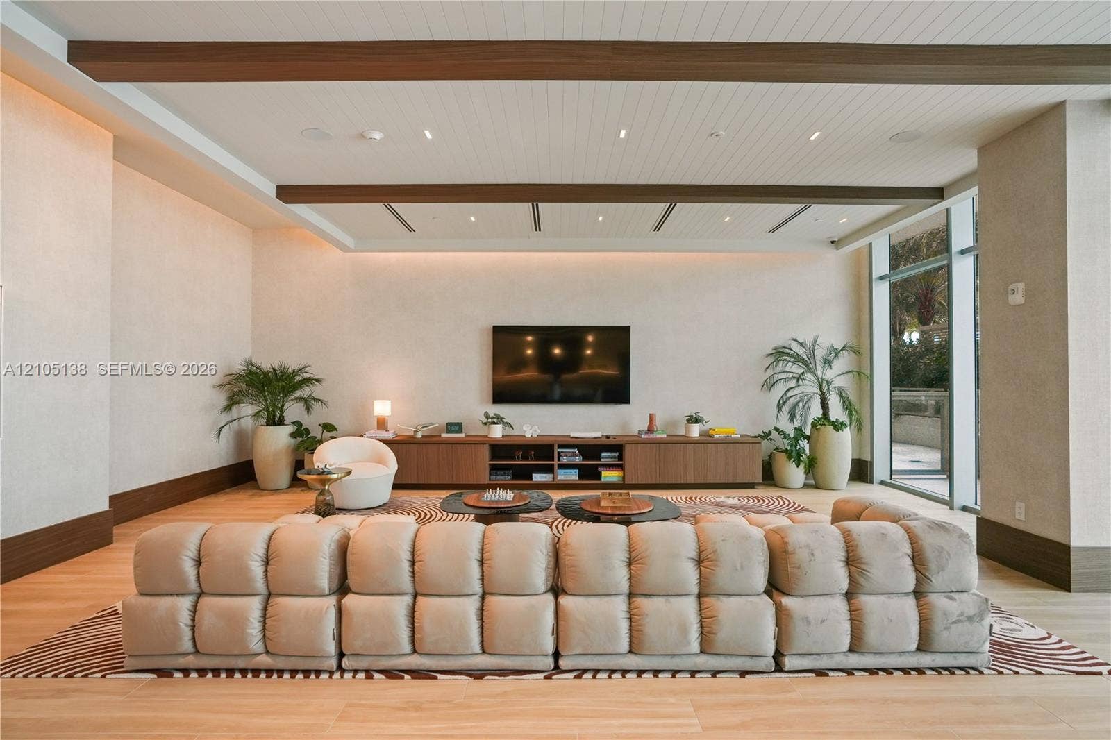 2411 Laguna Circle, #1505, North Miami, FL 33181 Wood-finish flooring, accent wall, built-in media console, recessed lighting, floor-to-ceiling window
