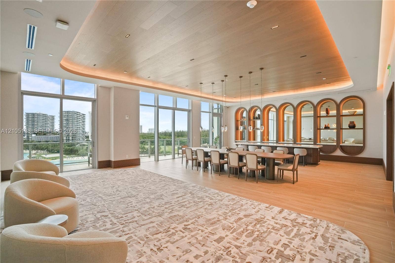 2411 Laguna Circle, #1505, North Miami, FL 33181 Expansive room with floor-to-ceiling windows, wood-finish flooring, and a curved wood-panel ceiling with integrated lighting