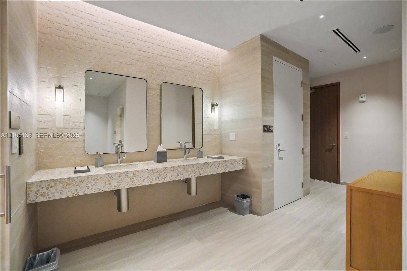 2411 Laguna Circle, #1505, North Miami, FL 33181 Floating double vanity with a speckled countertop, undermount sinks, and wall-mounted faucets