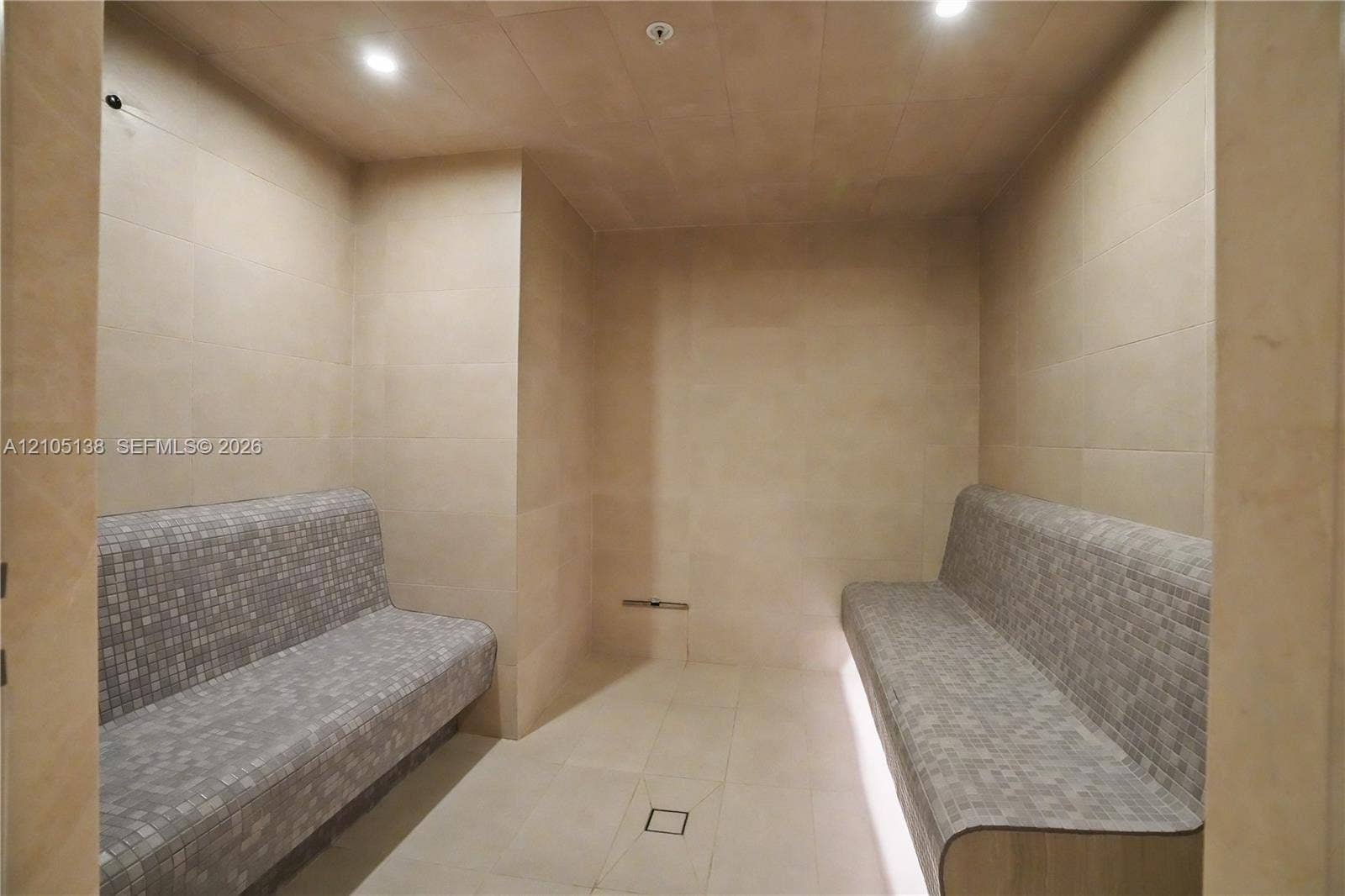 2411 Laguna Circle, #1505, North Miami, FL 33181 Tiled interior featuring recessed lighting, two built-in tiled benches, and a central floor drain