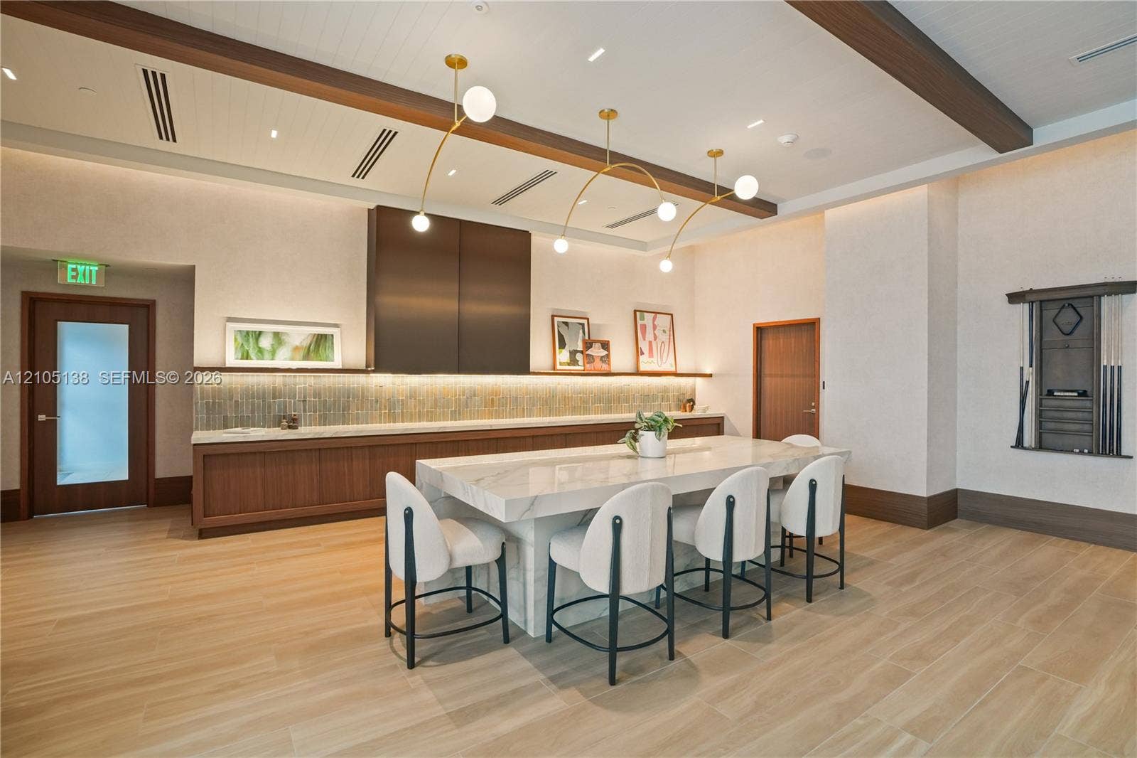 2411 Laguna Circle, #1505, North Miami, FL 33181 Wood-finish flooring with a large stone-finish communal table