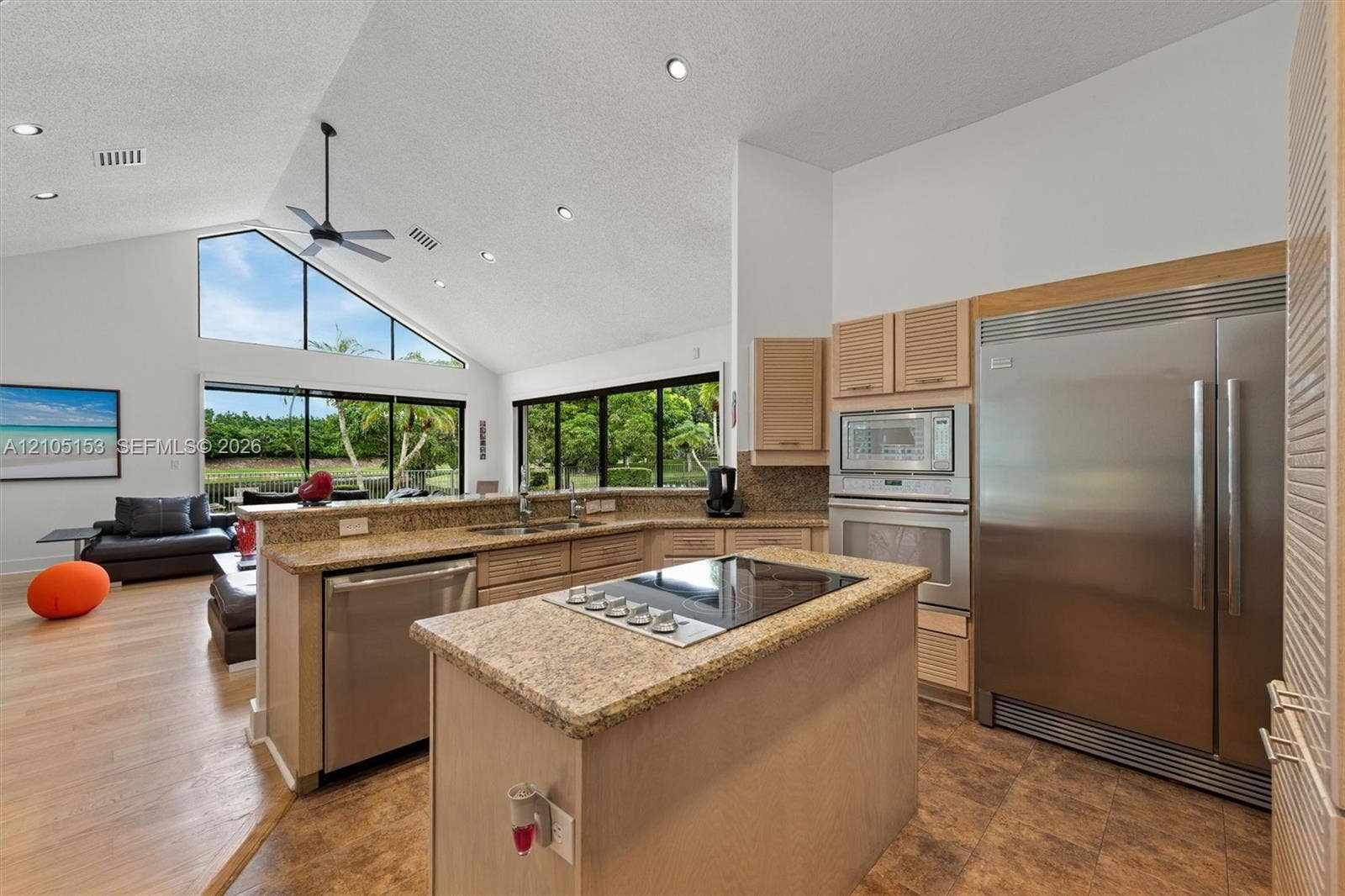Vaulted ceilings with recessed lighting, large triangular windows, ample natural light, granite countertops, and stainless steel appliances
