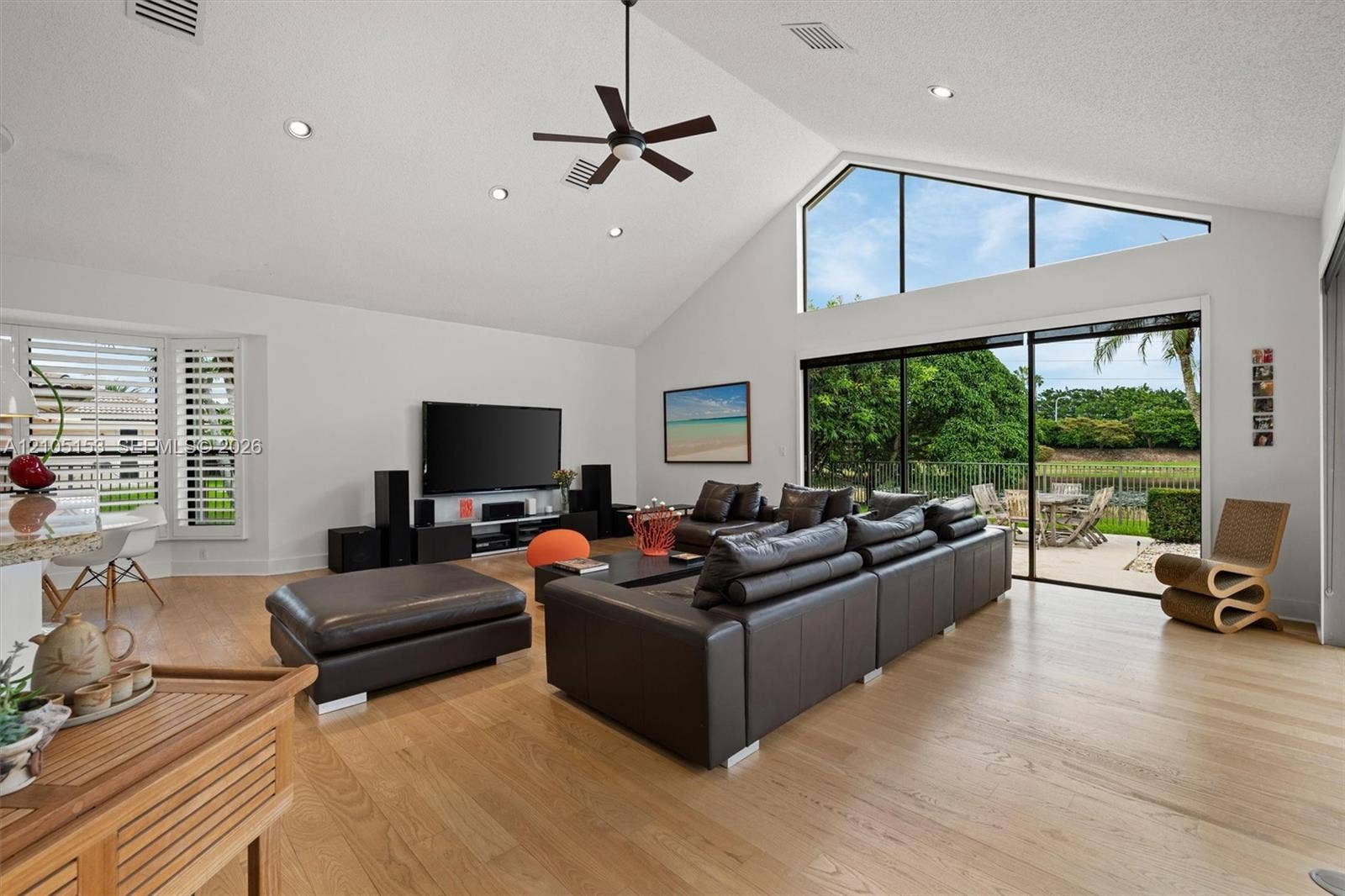 Vaulted ceiling with recessed lighting and a ceiling fan