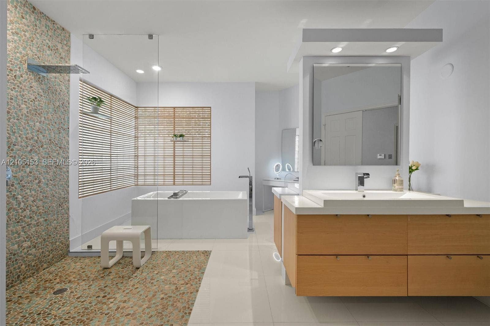 Floating wood-finish vanity with an integrated rectangular sink and polished chrome faucet