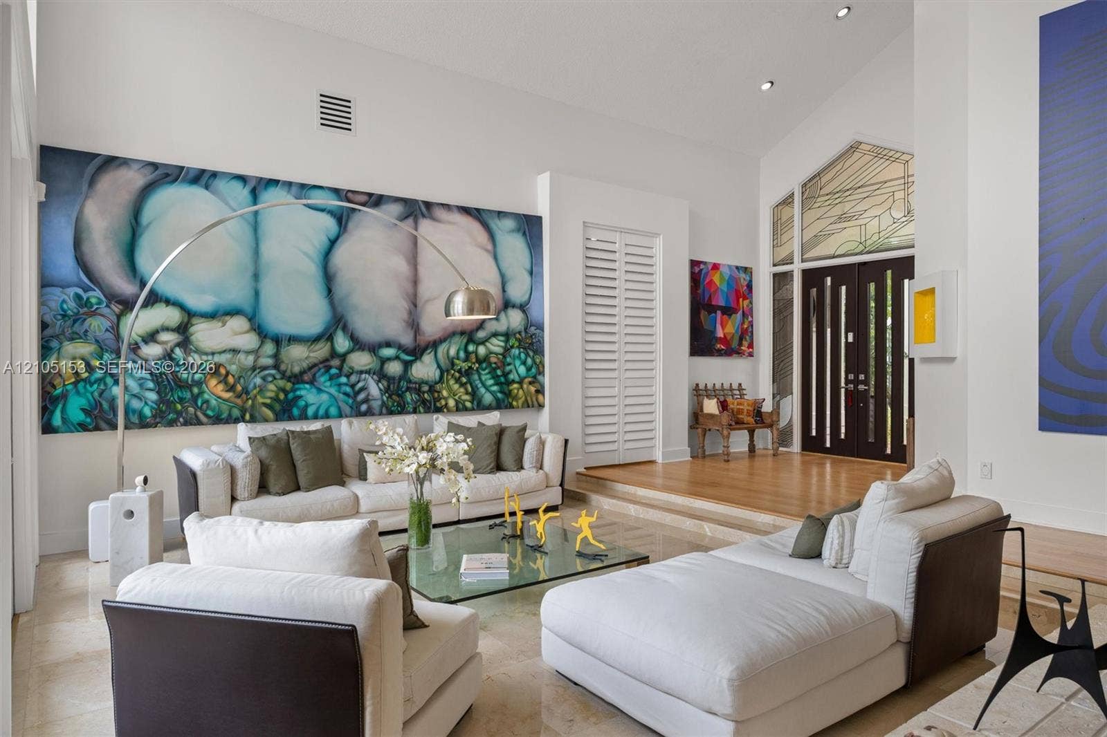 Vaulted ceilings, recessed lighting, and a raised entry with double doors