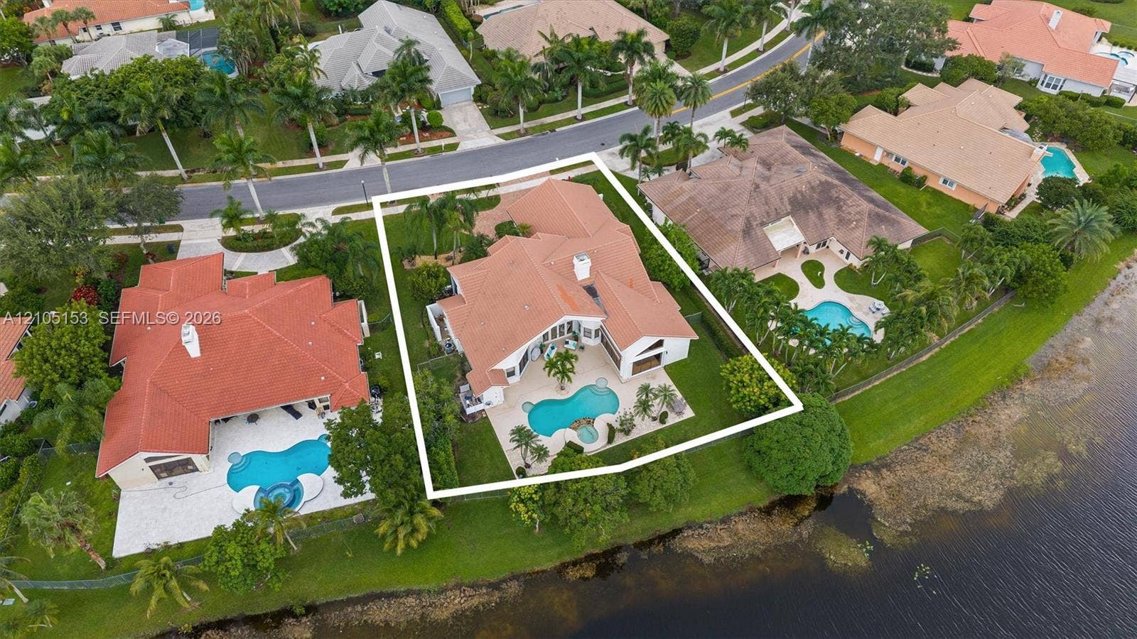 Mediterranean-style residence with a red tile roof and white exterior