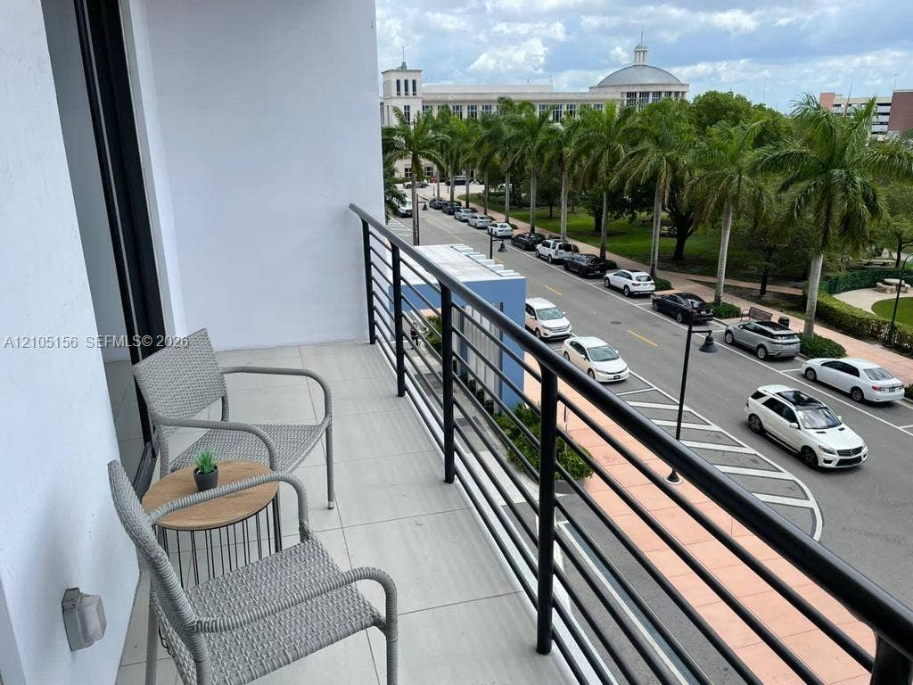 5350 NW 84th Avenue, #303, Doral, FL 33166 Private balcony featuring large-format tile flooring and a black metal railing
